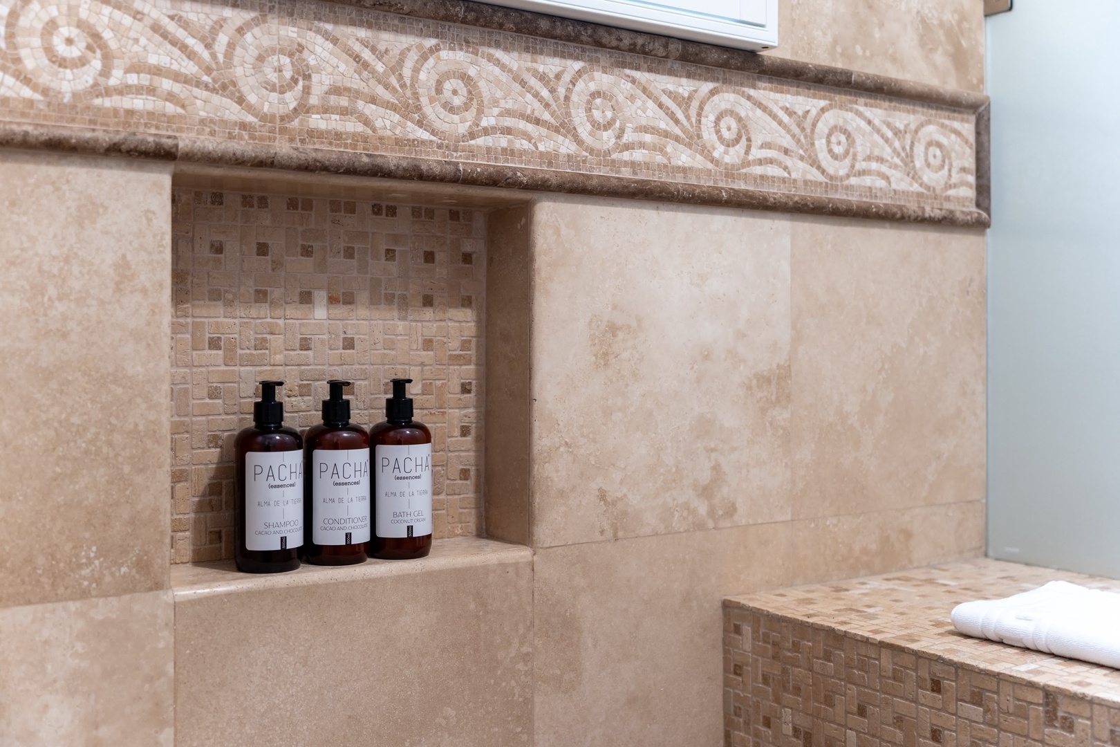Pamper yourself with luxurious spa amenities tucked into this elegant stone niche, where premium bath products await your relaxation ritual.