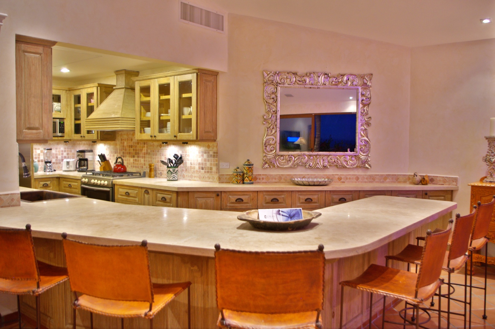 Your spacious kitchen features warm wood cabinetry, granite counters, and a large island with seating—perfect for preparing meals and gathering with loved ones in comfort.