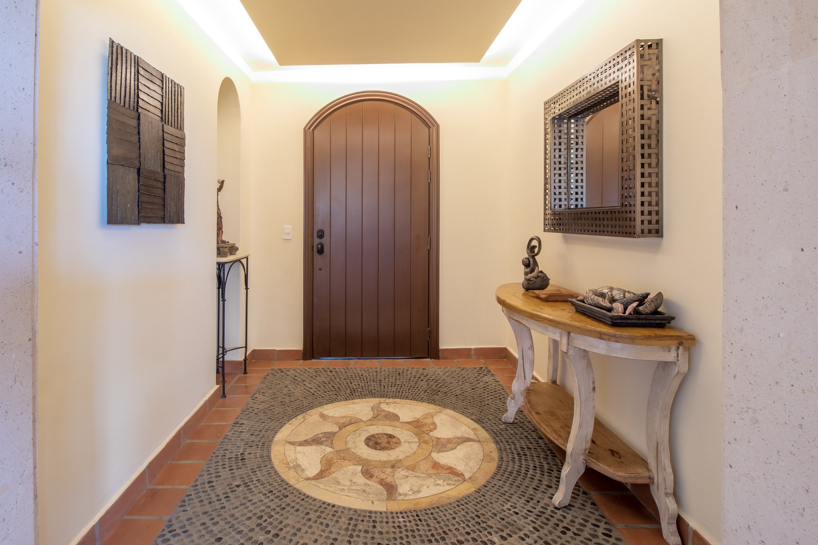 Step into your welcoming entrance, where rustic charm meets elegant design. The arched wooden door and decorative details set the tone for your relaxing escape.