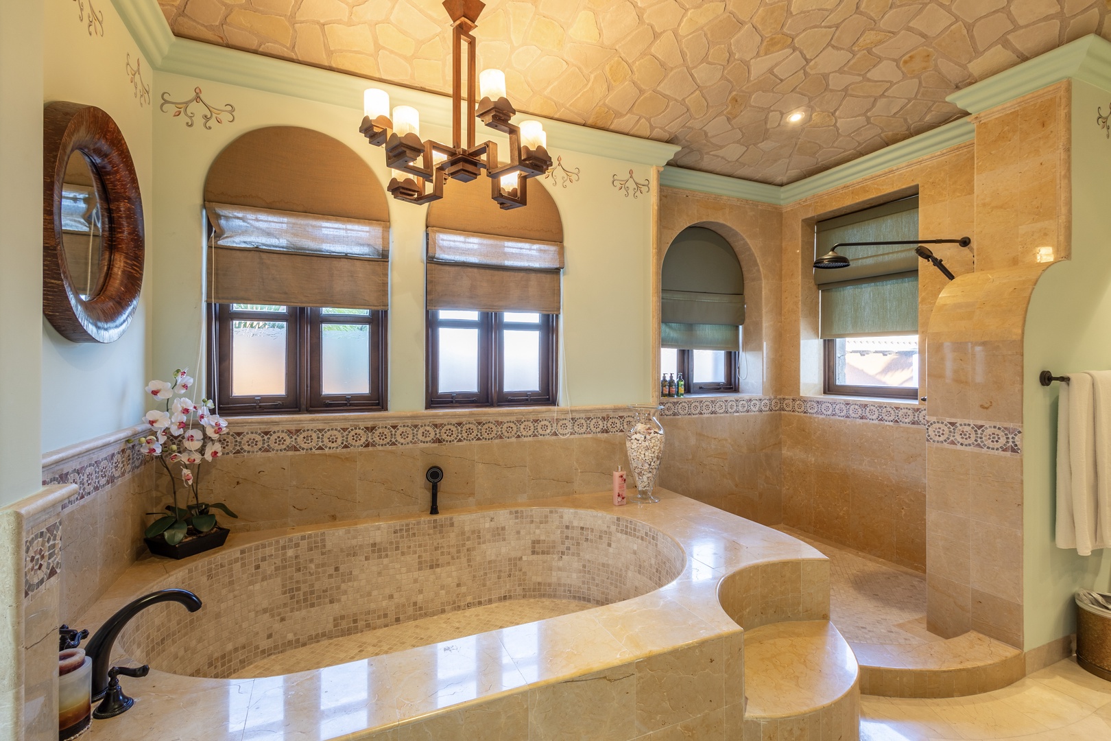 Step into your own private spa sanctuary, where elegant archways, mosaic tilework, and a luxurious soaking tub await your ultimate relaxation. The walk-in shower and refined fixtures complete this stunning retreat.