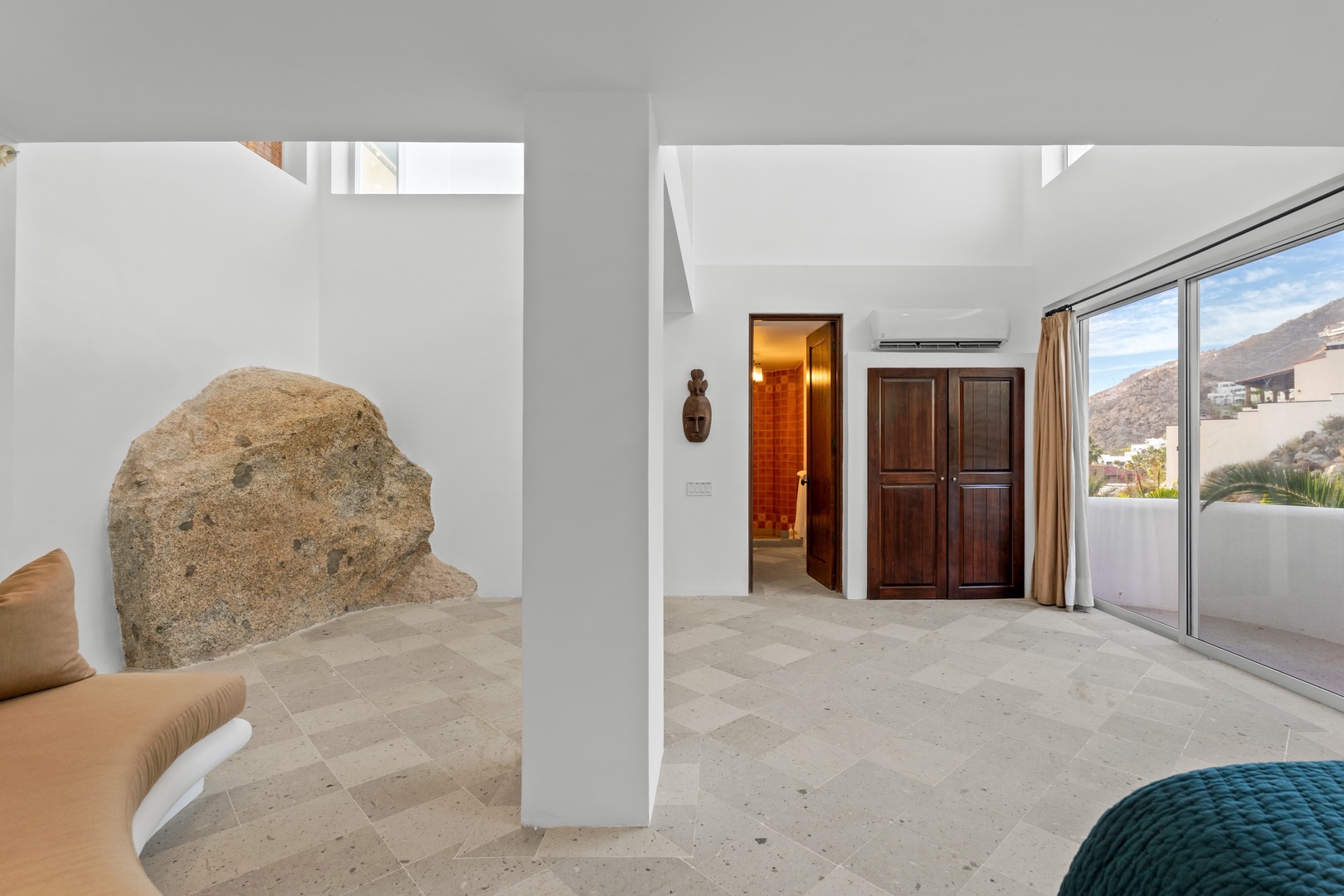 Unwind in your unique bedroom where natural stone meets modern comfort, featuring mountain views and peaceful surroundings.