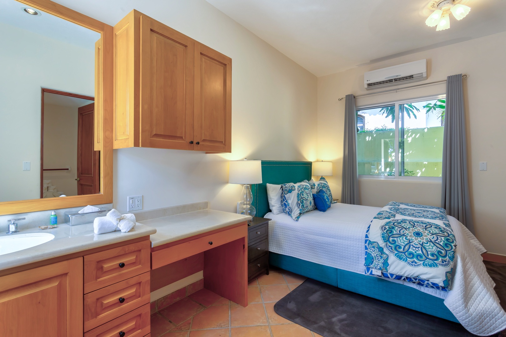 Unwind in your bright bedroom featuring a comfortable queen bed, built-in vanity, and air conditioning for perfect temperature control.