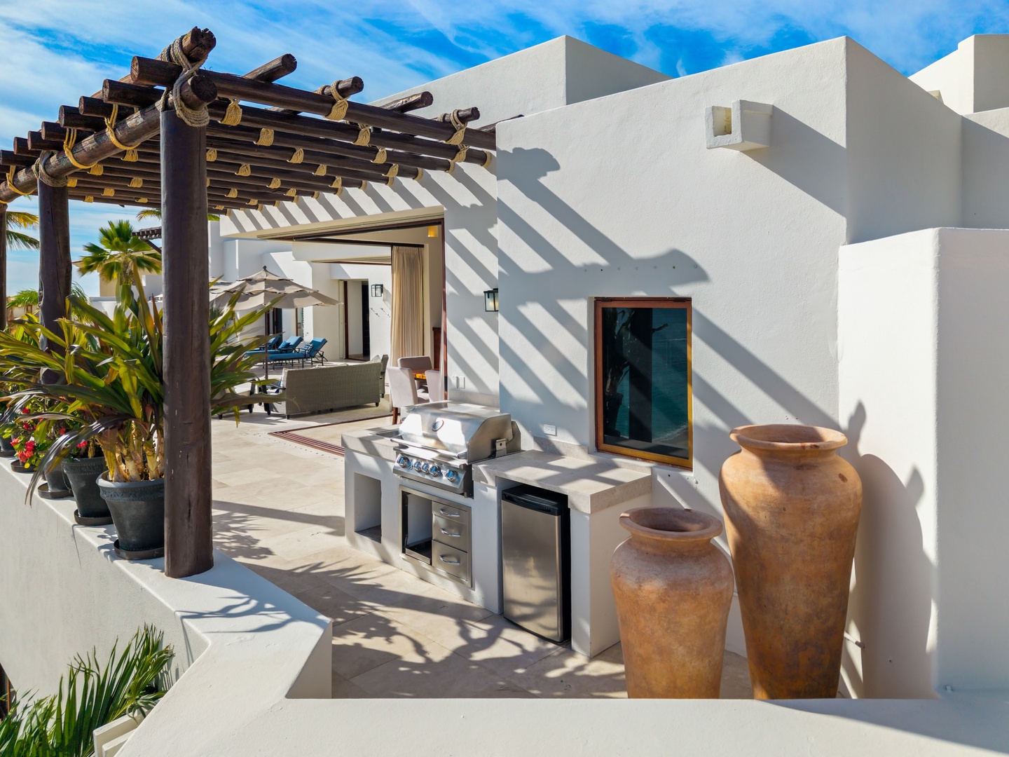 Your private outdoor kitchen awaits with professional grilling station and tropical pergola where you'll create memorable meals.