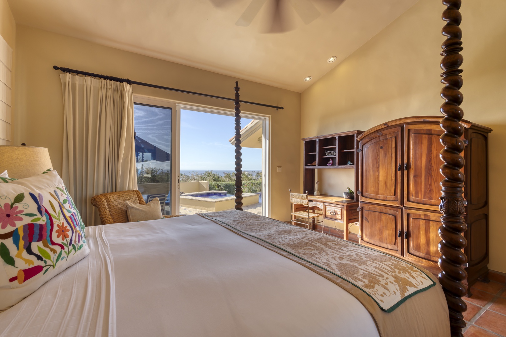 Wake up in your elegant bedroom featuring handcrafted wood furniture and stunning views through floor-to-ceiling windows.