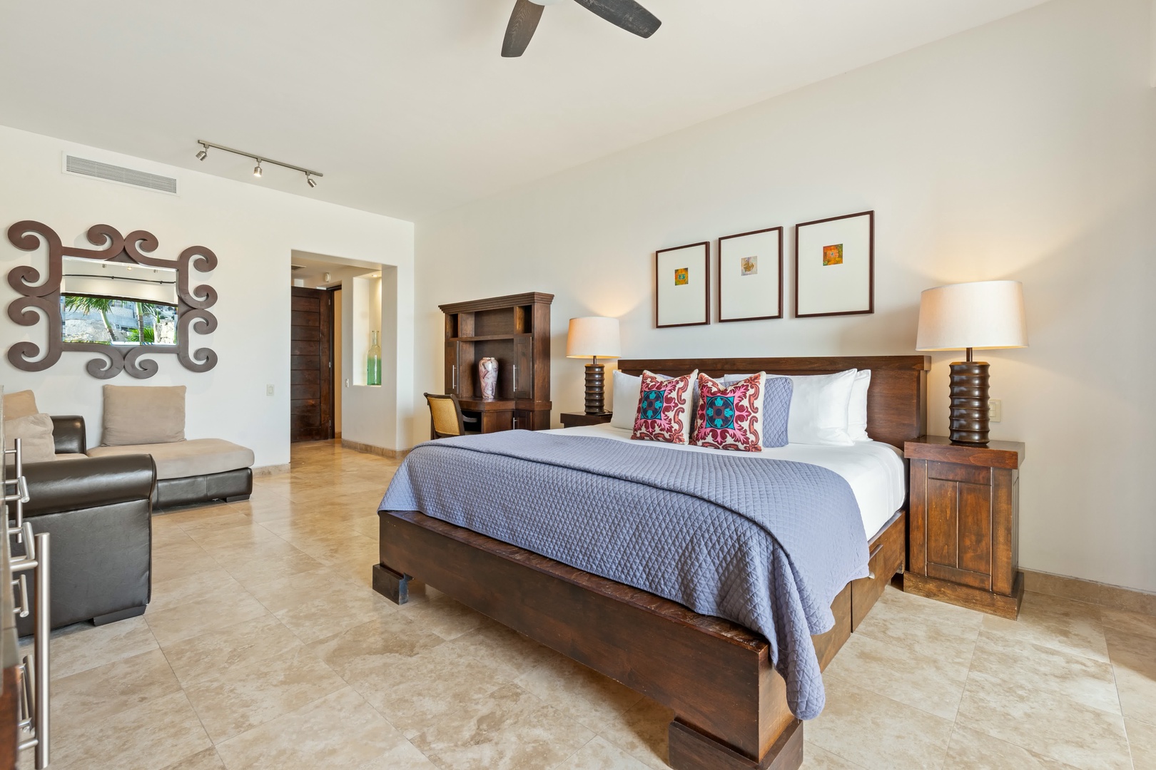 Sink into your king bed's plush linens and colorful pillows while enjoying the spacious seating area and elegant Mexican-inspired décor.