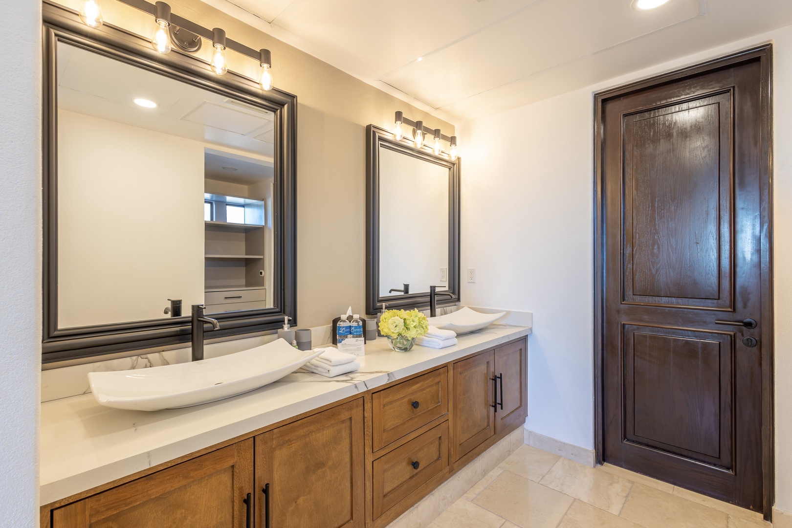 Refresh in your private bathroom with dual sinks, ample storage, and thoughtful touches like fresh towels and flowers to brighten your stay.
