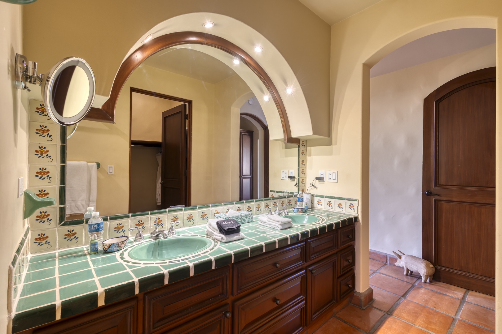Your elegant bathroom features handcrafted Talavera tiles, dual sinks, and warm Mexican charm with beautiful arched doorways.