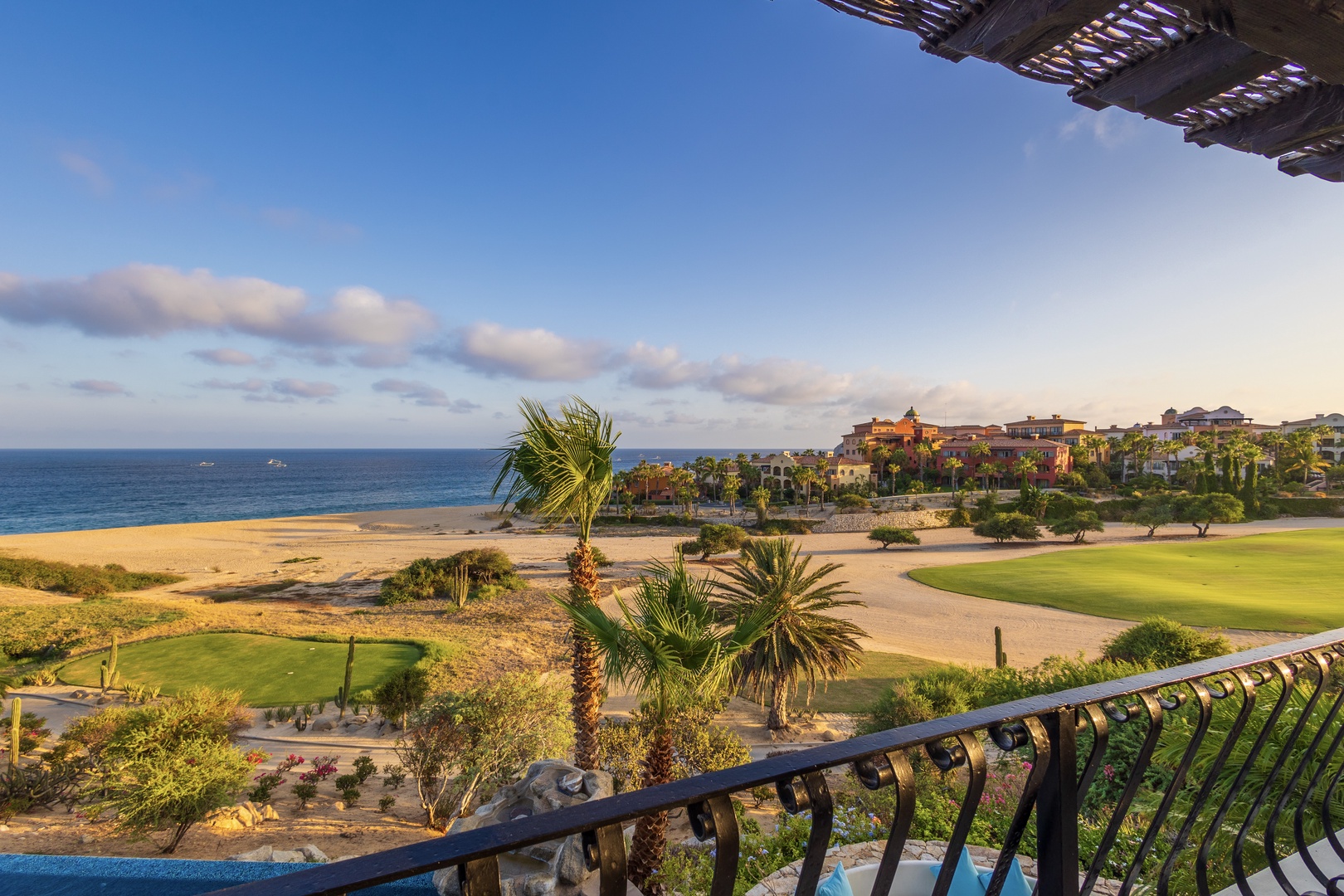 Sweeping views of the Sea of Cortez, pristine beach, and lush golf course create a stunning backdrop. The private balcony overlooks palm-dotted fairways and the sparkling ocean beyond.