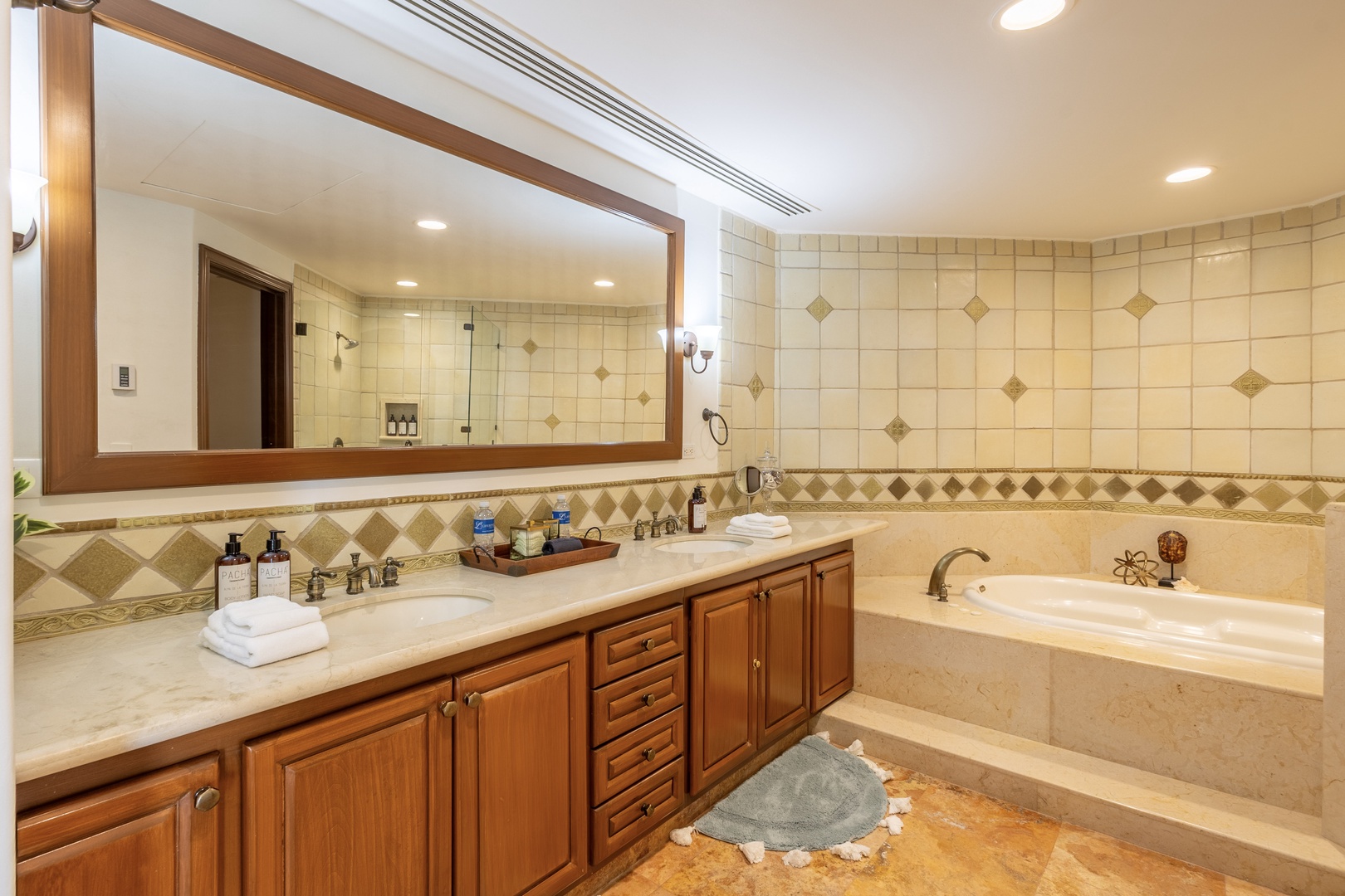 Unwind in your spa-like bathroom featuring a soaking tub, dual vanities, and elegant tile work for the ultimate relaxation retreat.