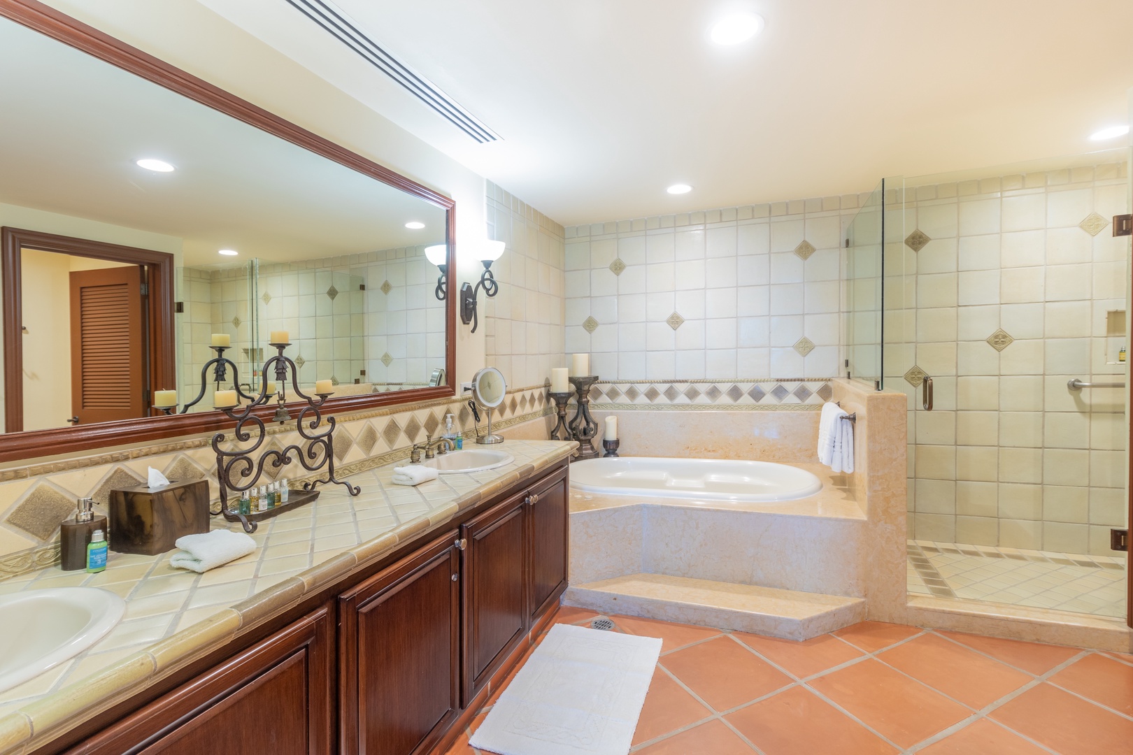 Soak away the day in your elegant sunken tub or refresh under the glass-enclosed shower, surrounded by warm tile and polished wood finishes that make every moment feel indulgent.