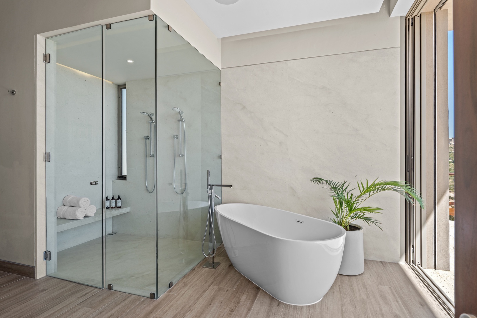 Slip into your private soaking tub and feel the day melt away in this spa-inspired sanctuary with a sleek walk-in shower and soft natural light streaming in.