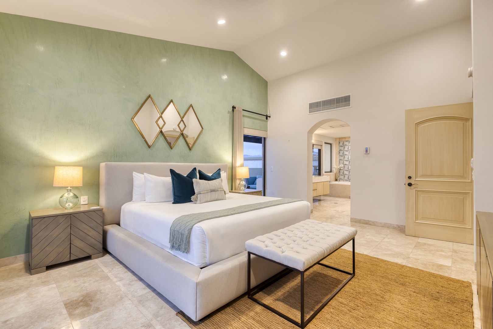 Your serene retreat awaits with a plush bed, calming sage accent wall, elegant décor, and soft lighting that invites restful nights.