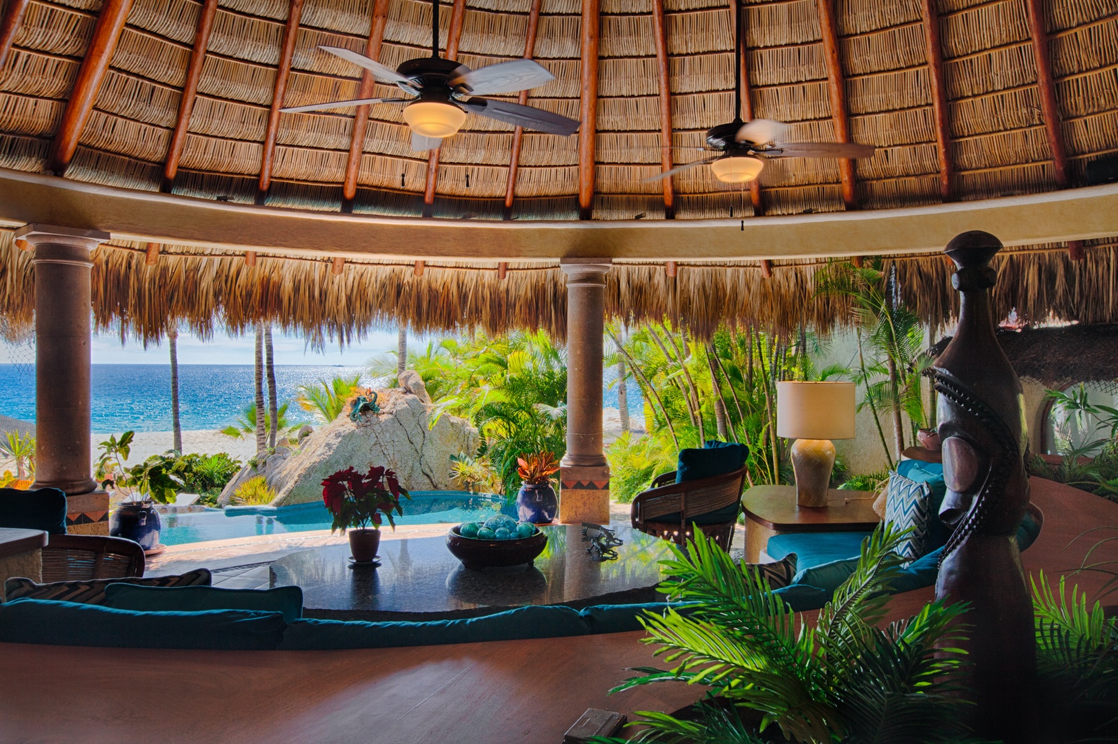 Unwind in your tropical paradise where thatched ceilings frame stunning ocean views through your private palapa lounge.