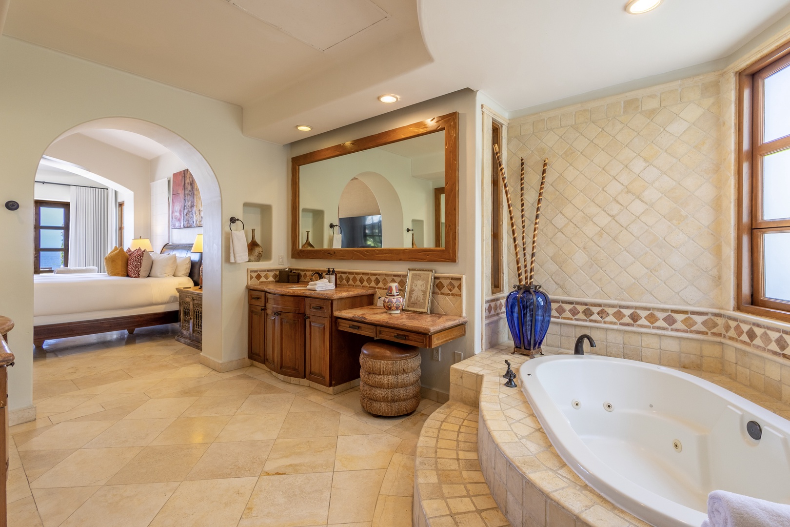 Unwind in your luxurious master bathroom featuring elegant tile work, spacious vanity, and a relaxing jetted tub perfect for romantic evenings.