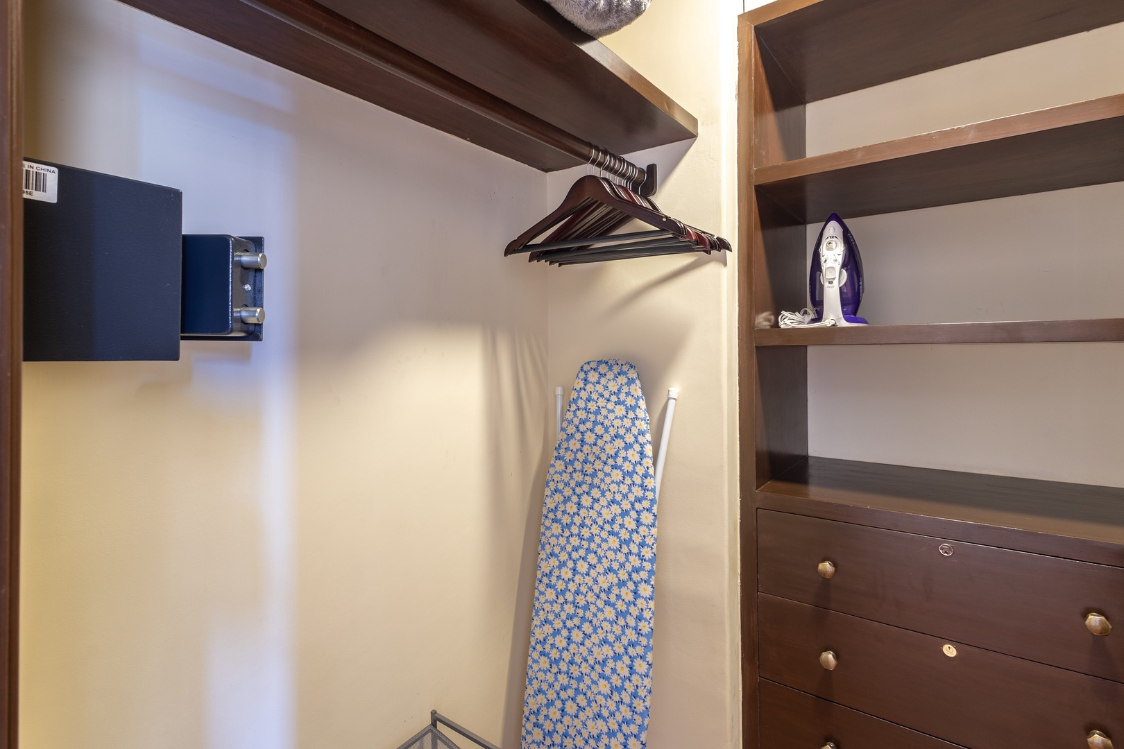 Your organized walk-in closet features ample hanging space, shelving for personal items, and a convenient iron with board—keeping your wardrobe fresh and wrinkle-free throughout your stay.