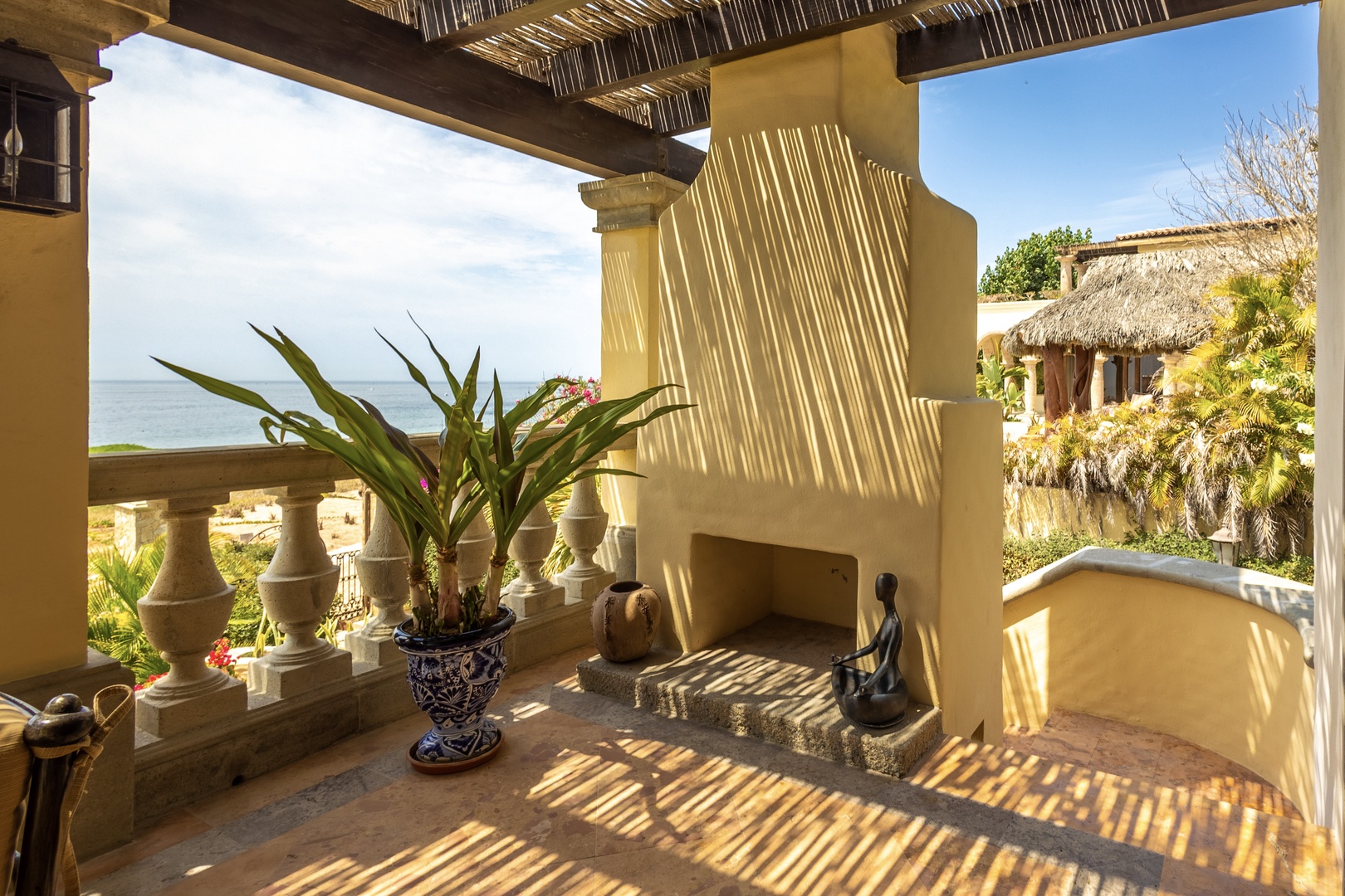 Your private terrace features a handcrafted fireplace, ocean views, and tropical gardens. Relax under the palapa roof as sunlight filters through, creating a serene retreat just steps from the sea.