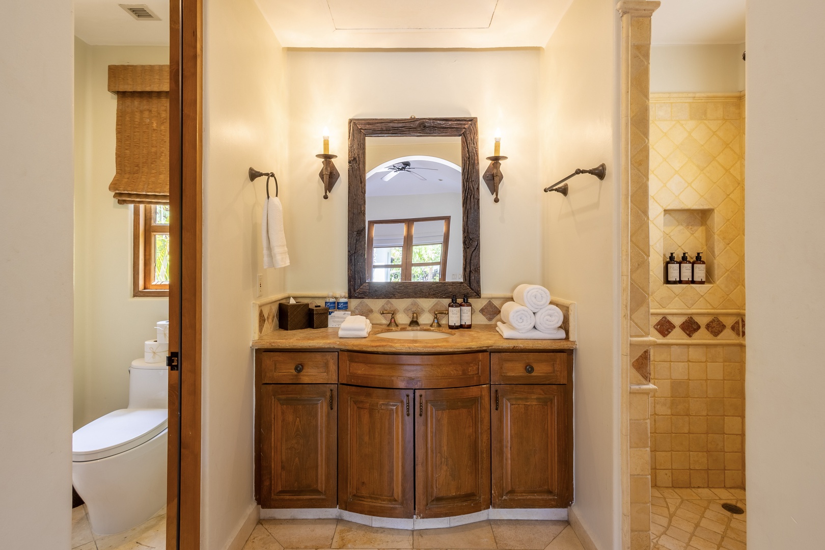 Unwind in your private sanctuary with rustic wood vanity, fluffy towels, and a spacious tiled shower waiting for you.