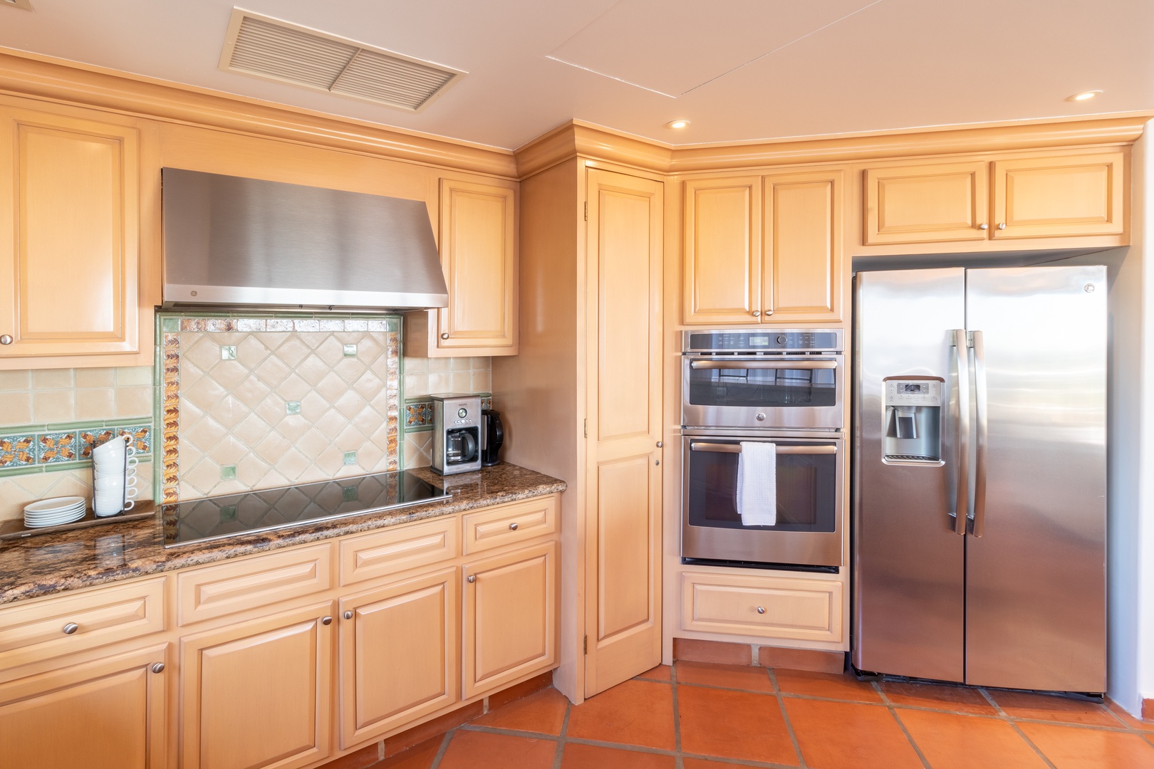 Picture yourself preparing a delicious meal in this well-appointed kitchen with granite counters, stainless steel appliances, and beautiful tiled floors—all ready for your vacation cooking adventures.