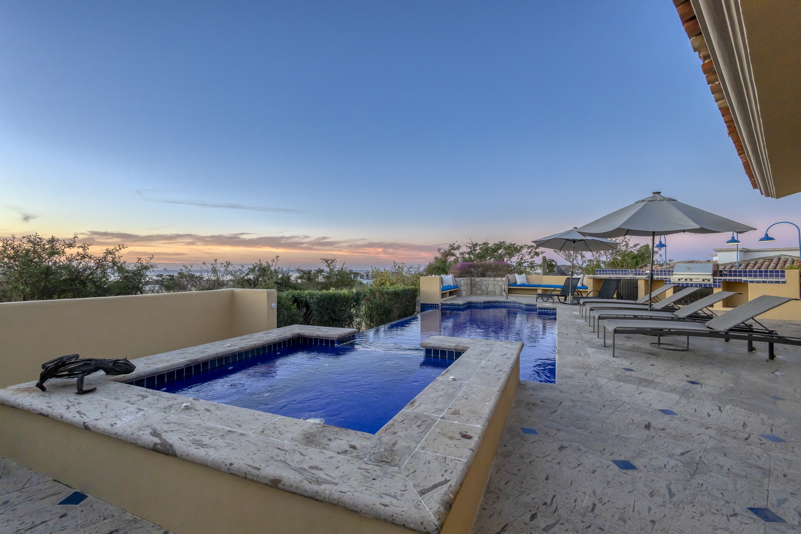 Unwind in your private pool area as twilight paints the sky in soft pastels, with comfortable loungers awaiting your evening relaxation.