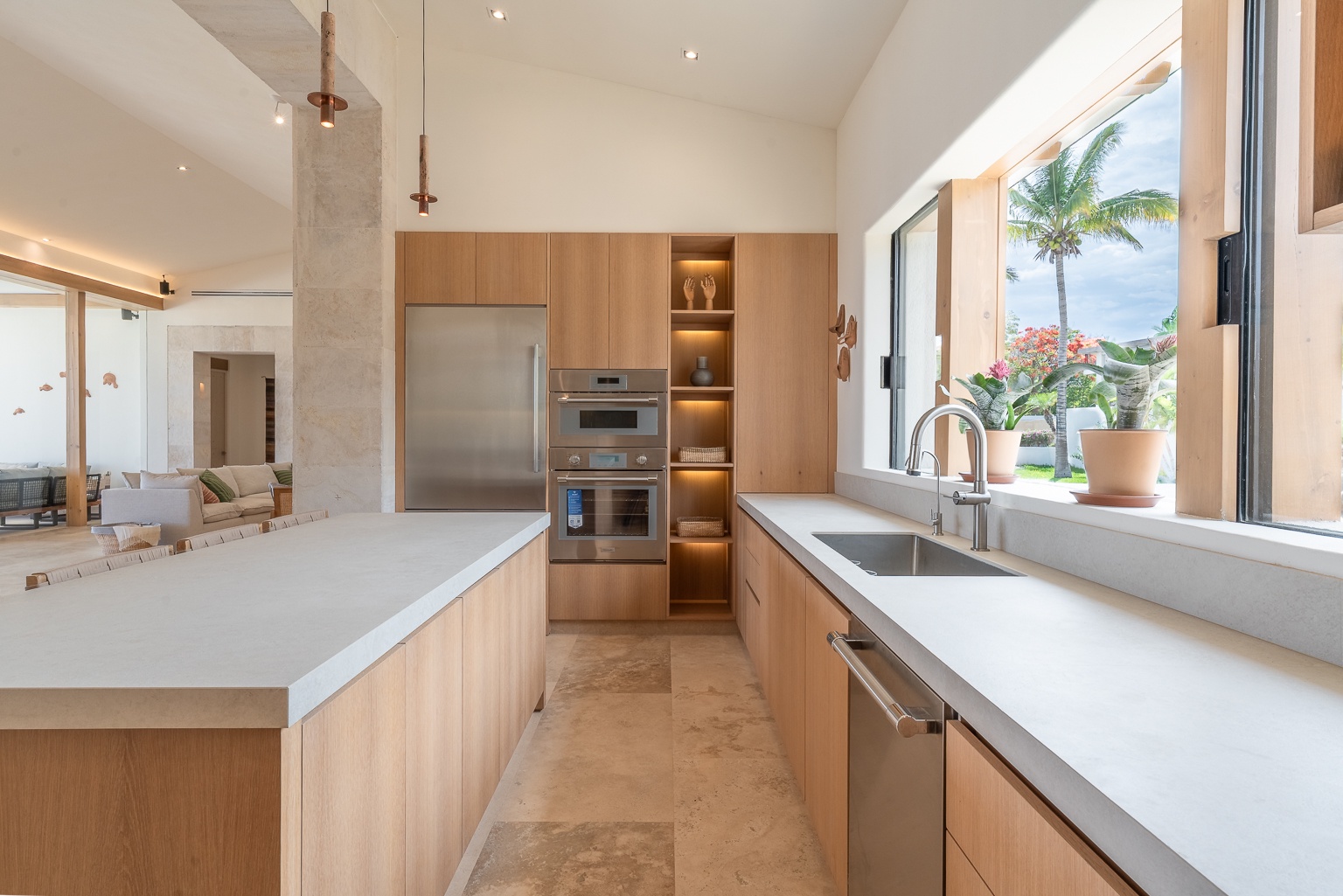 Your gourmet kitchen awaits with custom cabinetry, premium appliances, and expansive counters overlooking tropical gardens—perfect for preparing island-inspired meals in style.