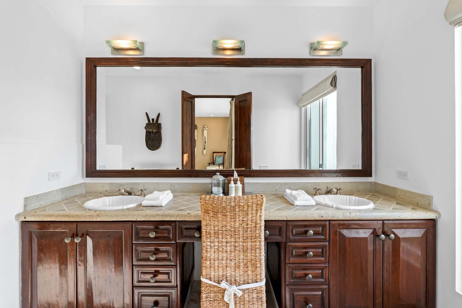 Your spacious dual-sink vanity offers elegant marble countertops and warm wood cabinetry, perfect for your morning routine.
