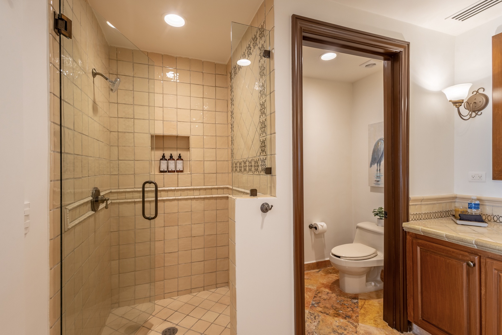Your elegant bathroom features a luxurious walk-in shower with glass doors and premium fixtures for your comfort.