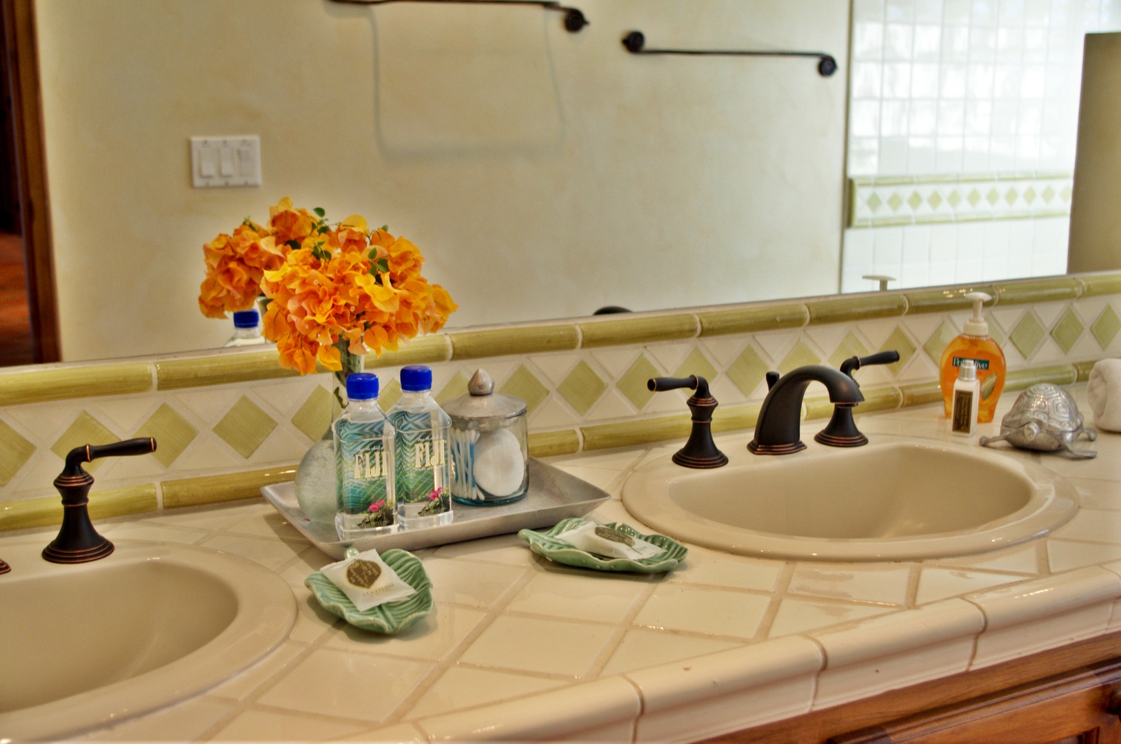 Two spacious sinks with elegant fixtures await you, complemented by thoughtful amenities and fresh flowers to brighten your morning routine.