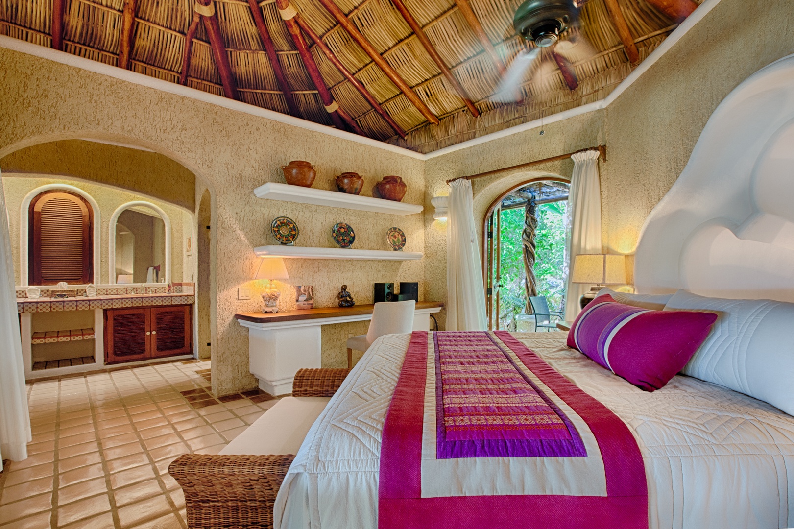Your luxurious bedroom features traditional Mexican architecture with bamboo ceiling, artisan textiles, and garden views for ultimate relaxation.