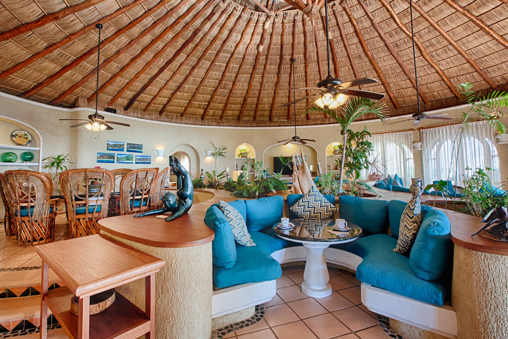 Unwind in your tropical paradise with soaring palapa ceilings, vibrant turquoise seating, and an open-concept design that blends indoor comfort with island charm.