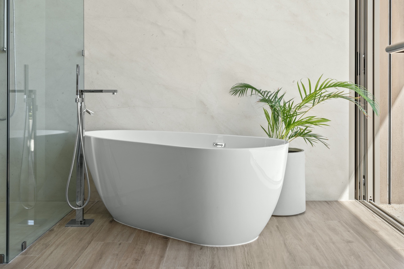 Unwind in your elegant soaking tub—a bright, modern sanctuary where a calming soak feels like a mini-retreat.