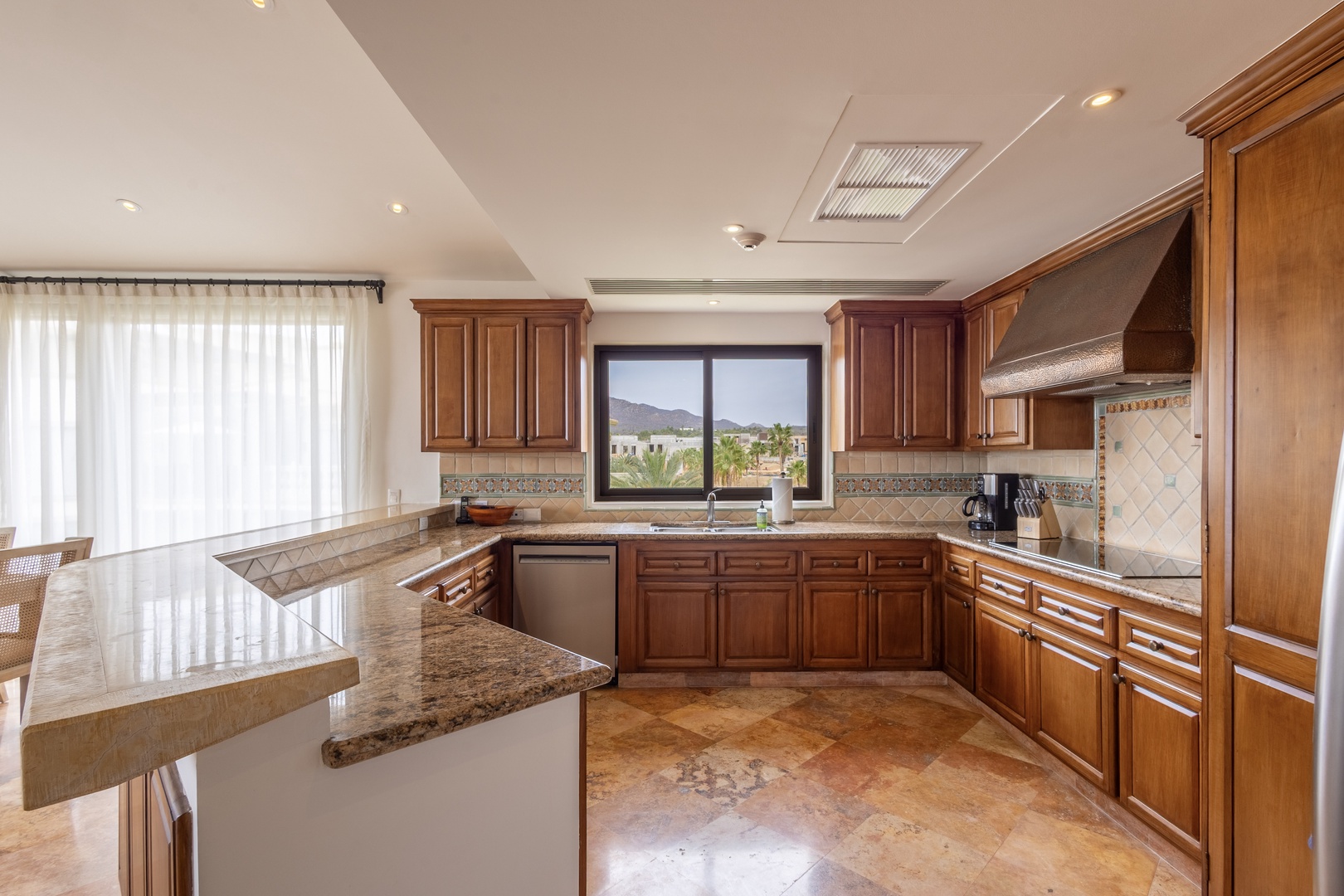 Your spacious gourmet kitchen features granite counters, rich wood cabinets, and mountain views for memorable meal prep.