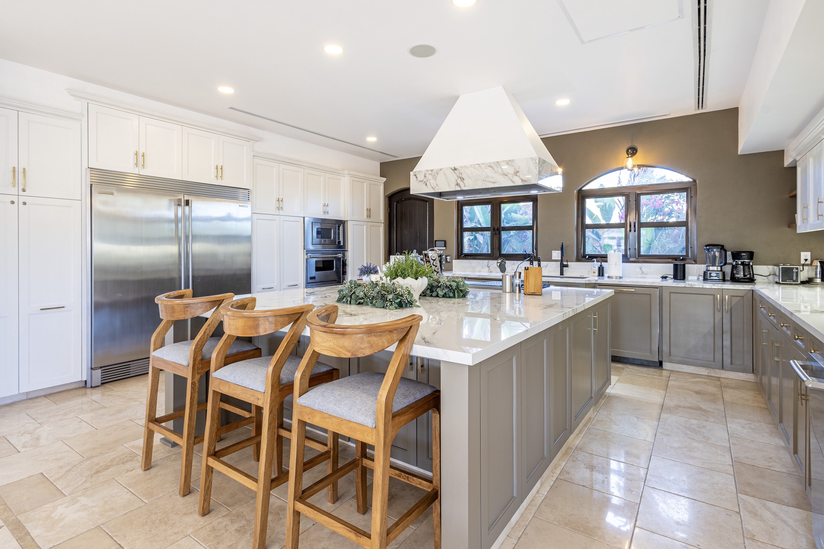 Gather around this gleaming marble island with your group, ready to whip up meals together in a fully-equipped chef's kitchen flooded with natural light.