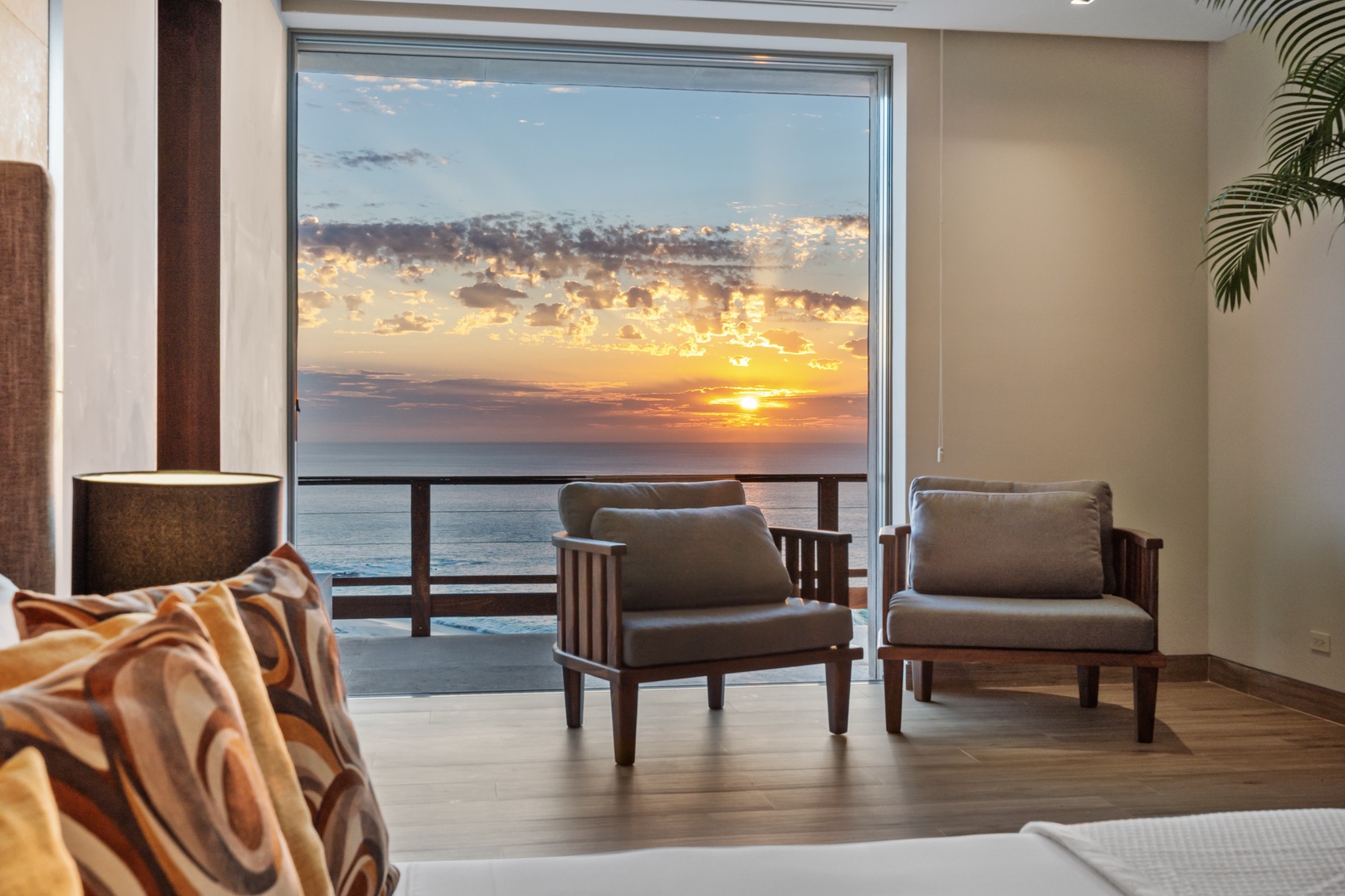 Watch the sun paint the sky in golden hues from your private balcony with sweeping ocean views—the perfect backdrop for your morning coffee or evening unwind.