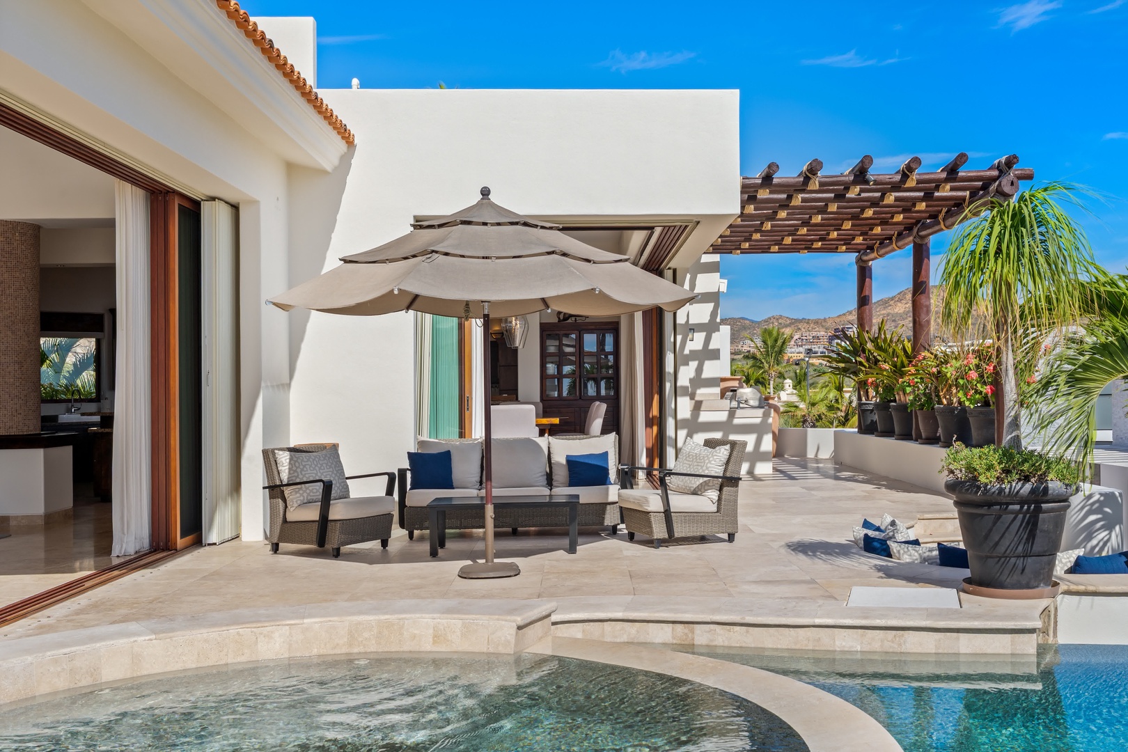 Your private poolside retreat awaits with comfortable seating under shade, perfect for relaxing with tropical breezes and stunning views.
