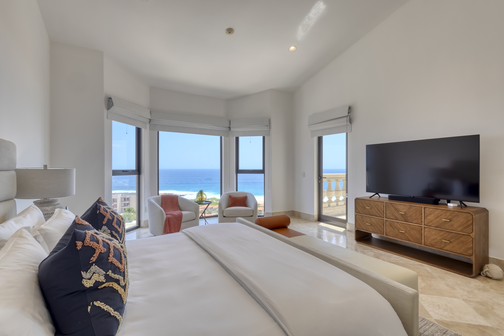 Wake up to breathtaking ocean views framed by floor-to-ceiling windows in your serene coastal bedroom. Crisp linens and modern furnishings create your perfect retreat.