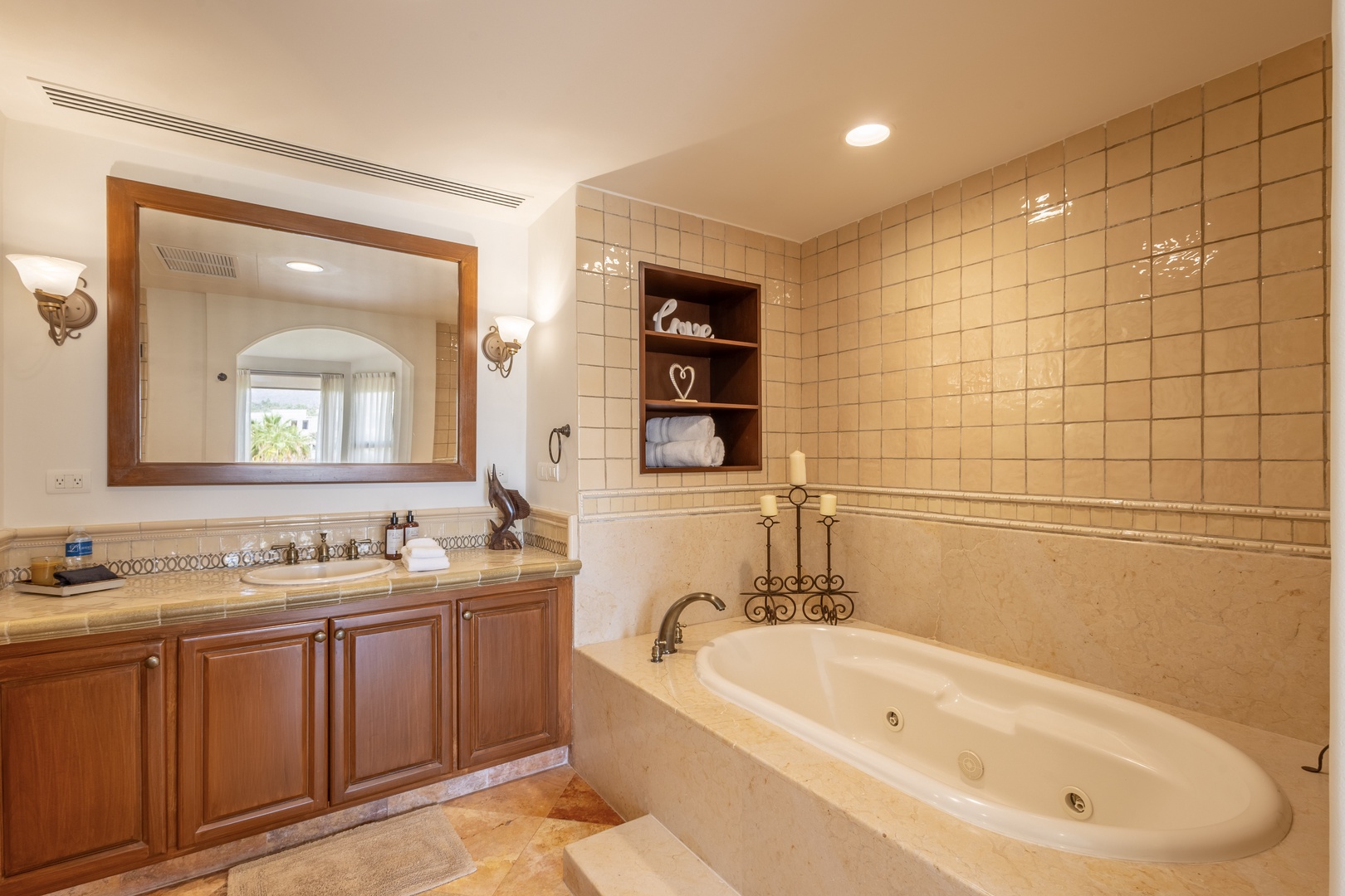 Soak your worries away in this luxurious marble bathroom, featuring a deep soaking tub and elegant vanity for your ultimate relaxation.