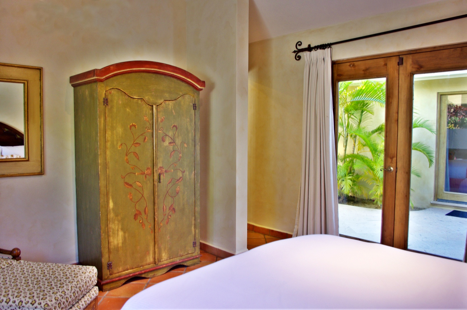 Step into your bright, inviting bedroom where tropical palms greet you just outside your door and charming vintage details welcome you home after a day of adventure.