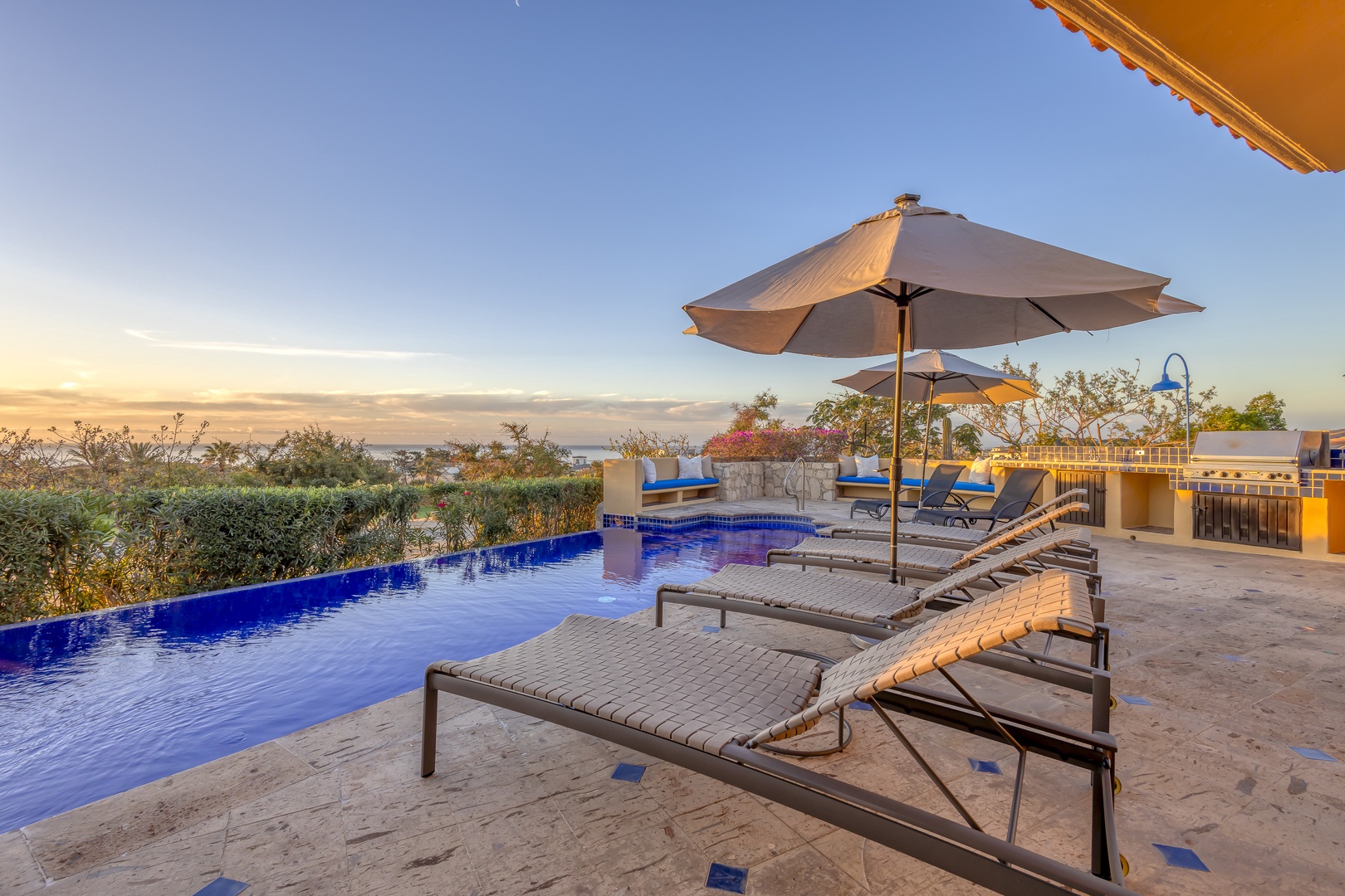 Unwind poolside on your private terrace as golden hour bathes the infinity pool in warm light, creating the perfect sunset sanctuary.