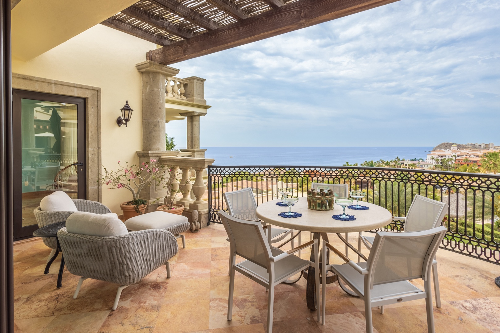 Savor morning coffee on your private terrace while taking in sweeping ocean views and coastal scenery from this elegant outdoor dining space.