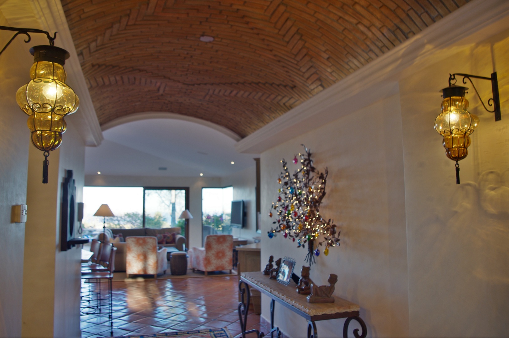 Step into a warm, inviting space where barrel vaulted brick ceilings, ambient lantern lighting, and thoughtful decor blend to create your perfect home away from home.