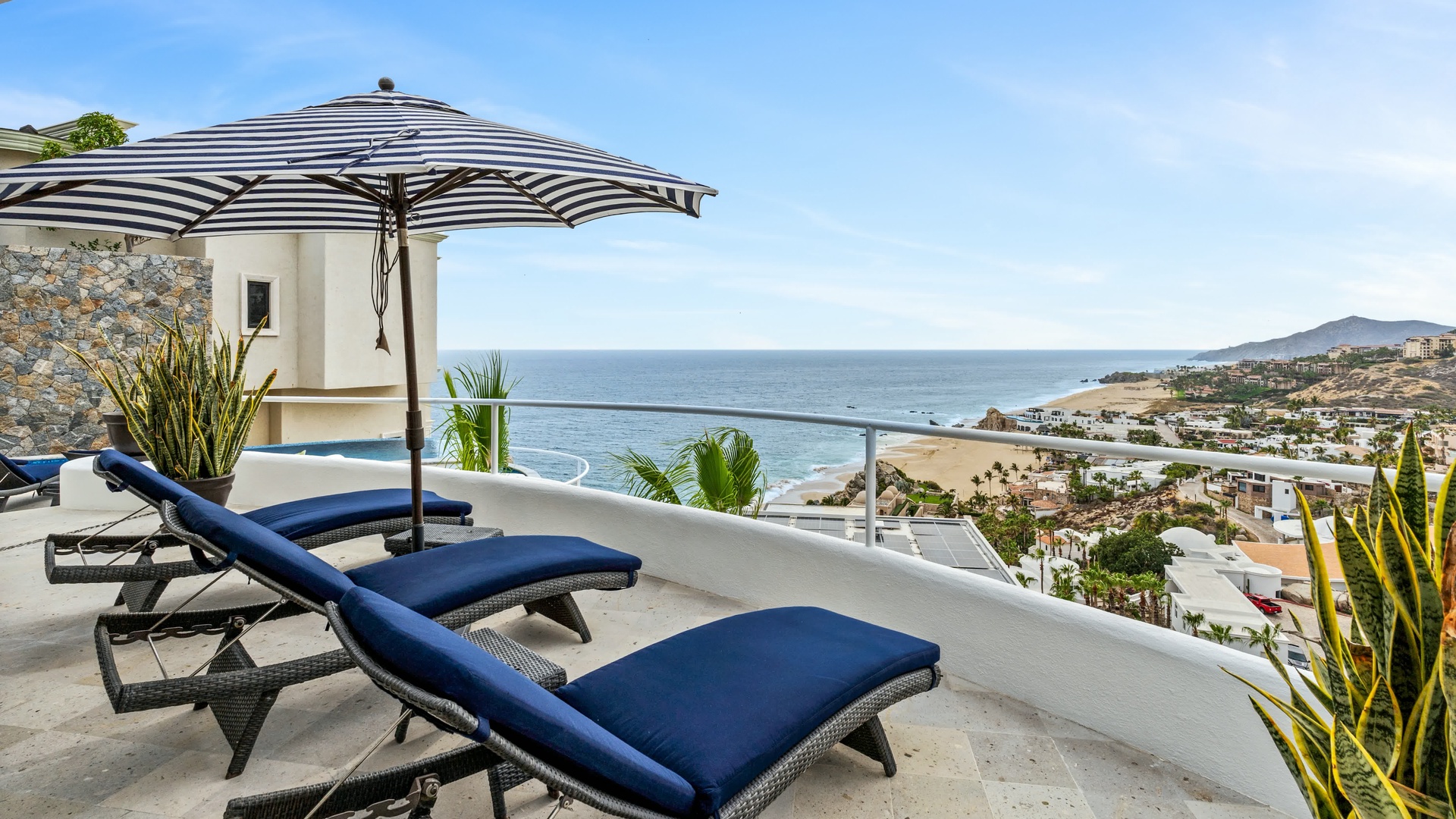 Unwind on your private terrace with stunning ocean views, comfortable loungers, and refreshing shade—your perfect retreat awaits.
