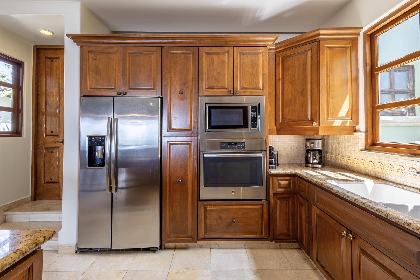 Your gourmet kitchen features rich wood cabinets, granite counters, and premium stainless steel appliances for memorable meal preparation.
