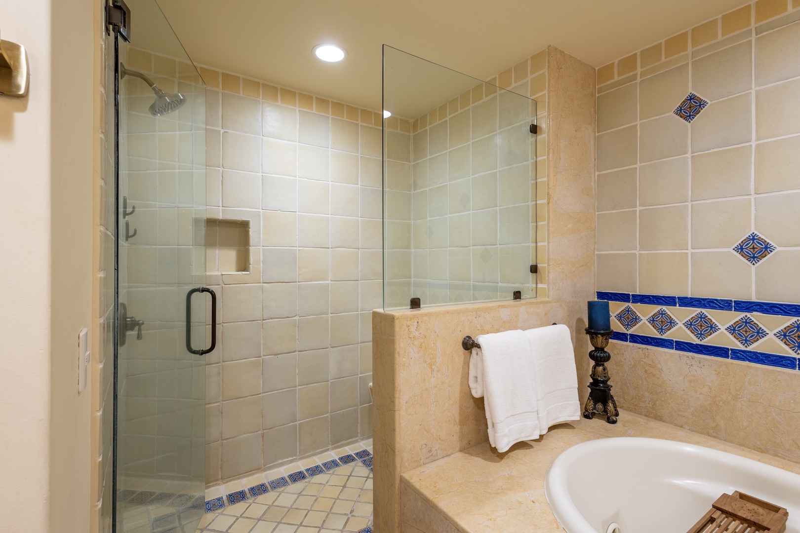 Unwind in your elegant spa-like bathroom featuring beautiful tile work and a spacious glass shower.