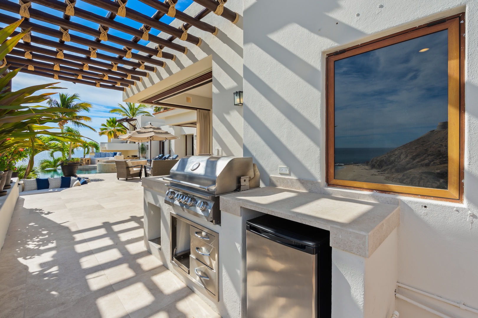 Fire up the grill while ocean breezes flow through your private outdoor kitchen, where palm trees frame endless sea views.