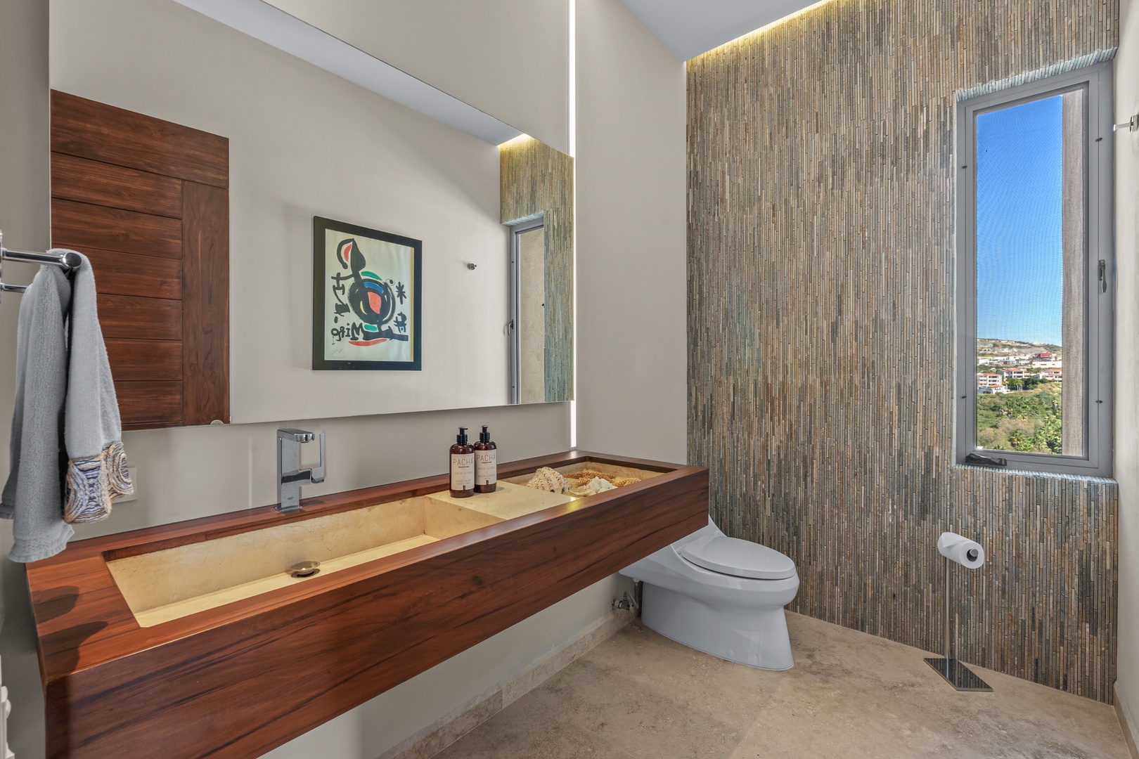 Light-filled retreat featuring a handcrafted wooden vanity, modern amenities, and a peaceful view that sets the stage for your relaxation.