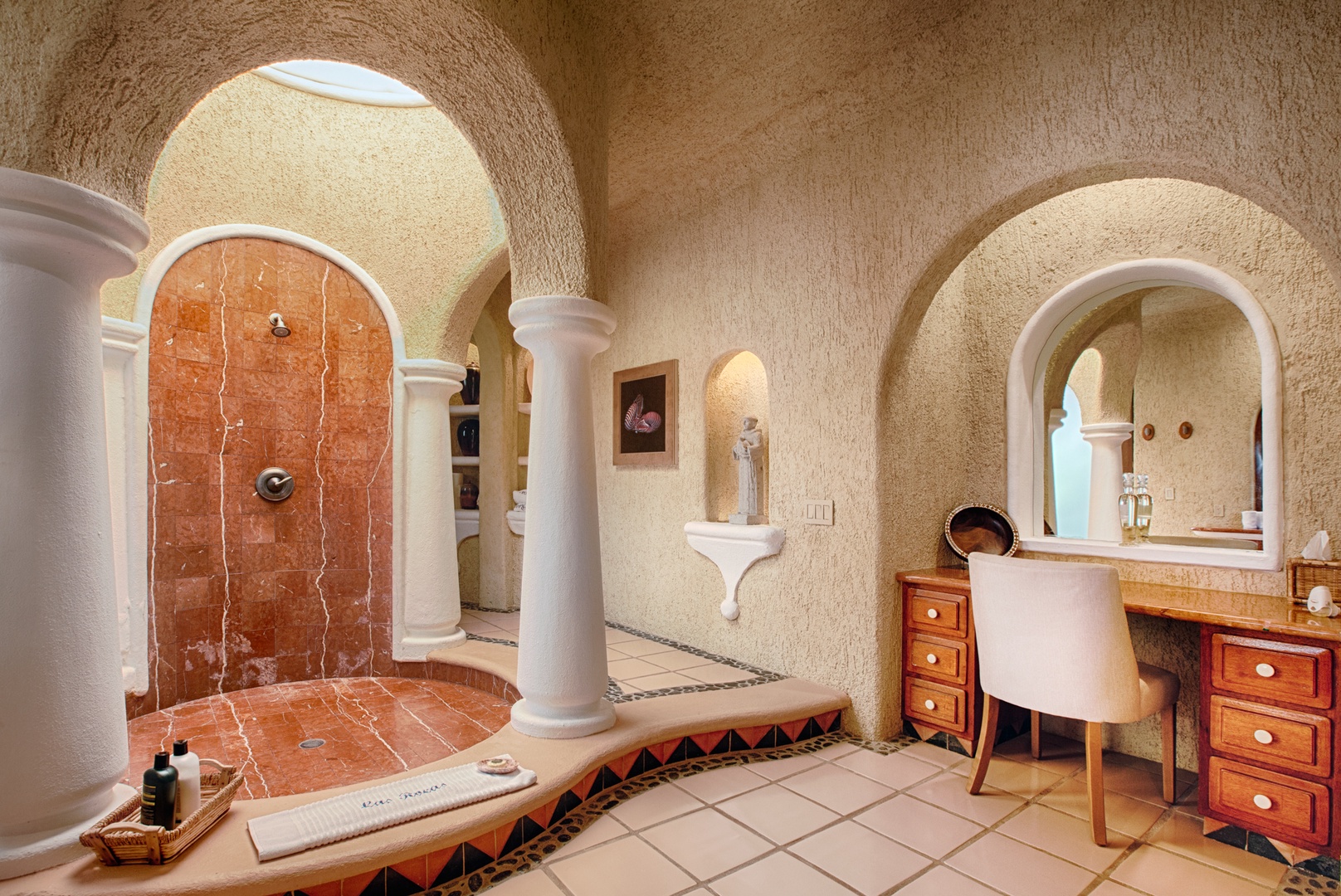 Step into your luxurious bathroom sanctuary with a stunning walk-in shower, elegant vanity, and charming Mediterranean archways that create a spa-like retreat.