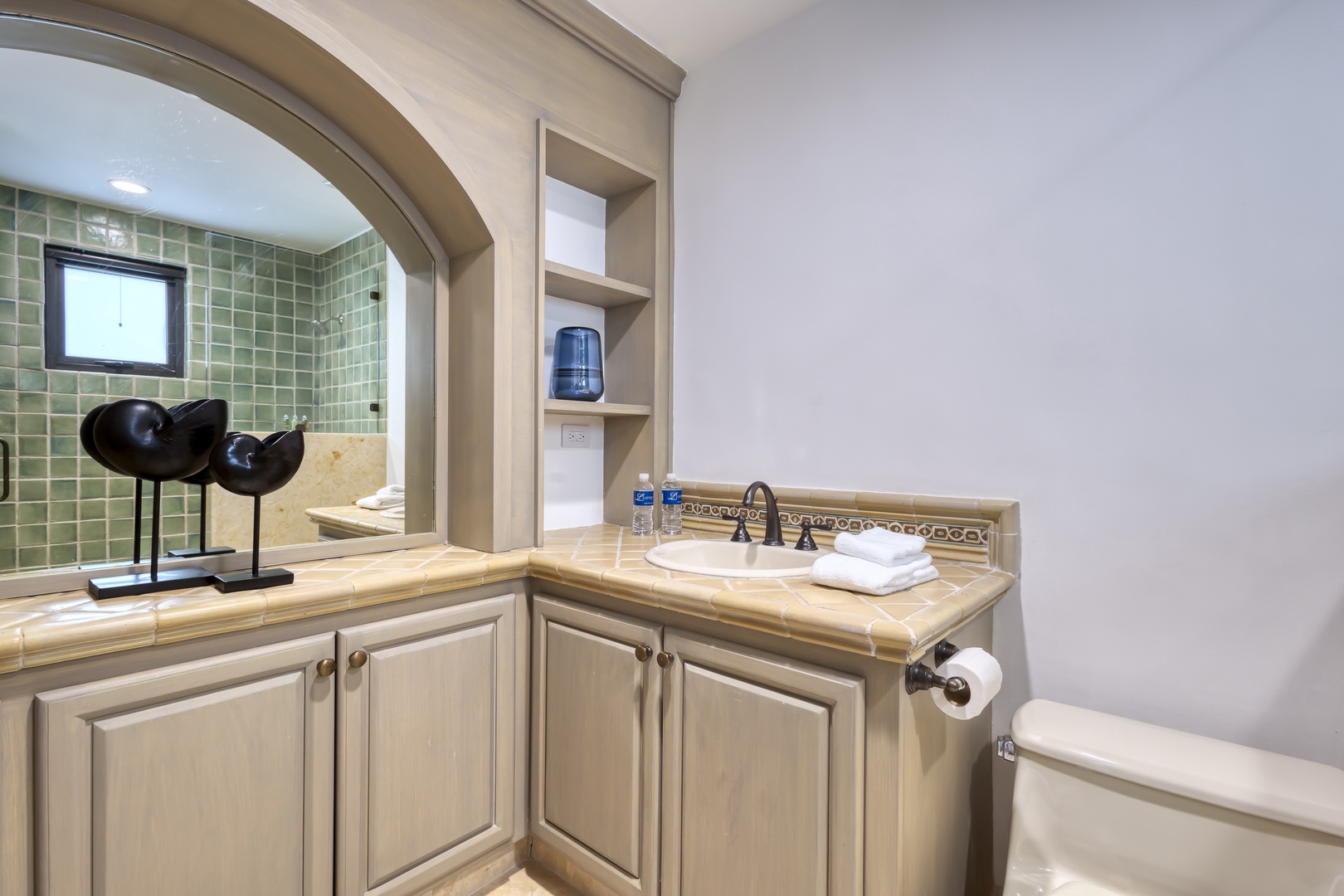 Refresh and unwind in your private bathroom with elegant green tile, crisp white towels, and thoughtful touches that make settling in effortless.