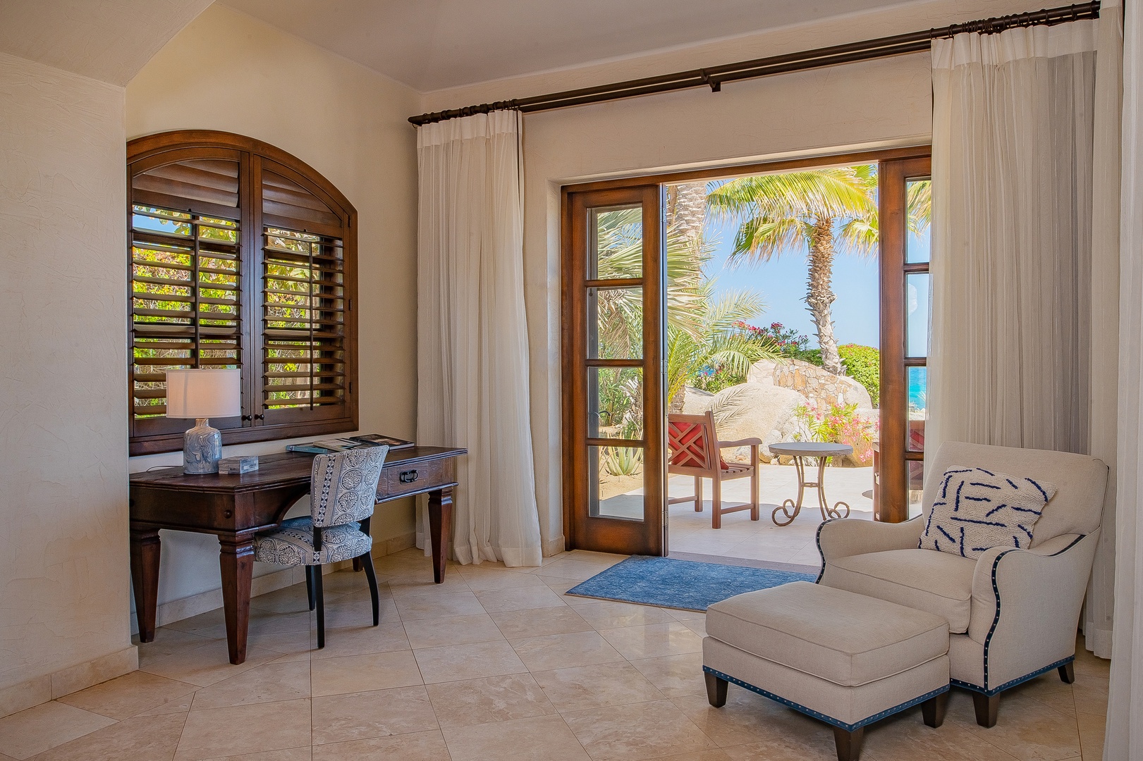 Your elegant workspace flows seamlessly to your private terrace, where palm trees frame stunning ocean views for the perfect tropical retreat.