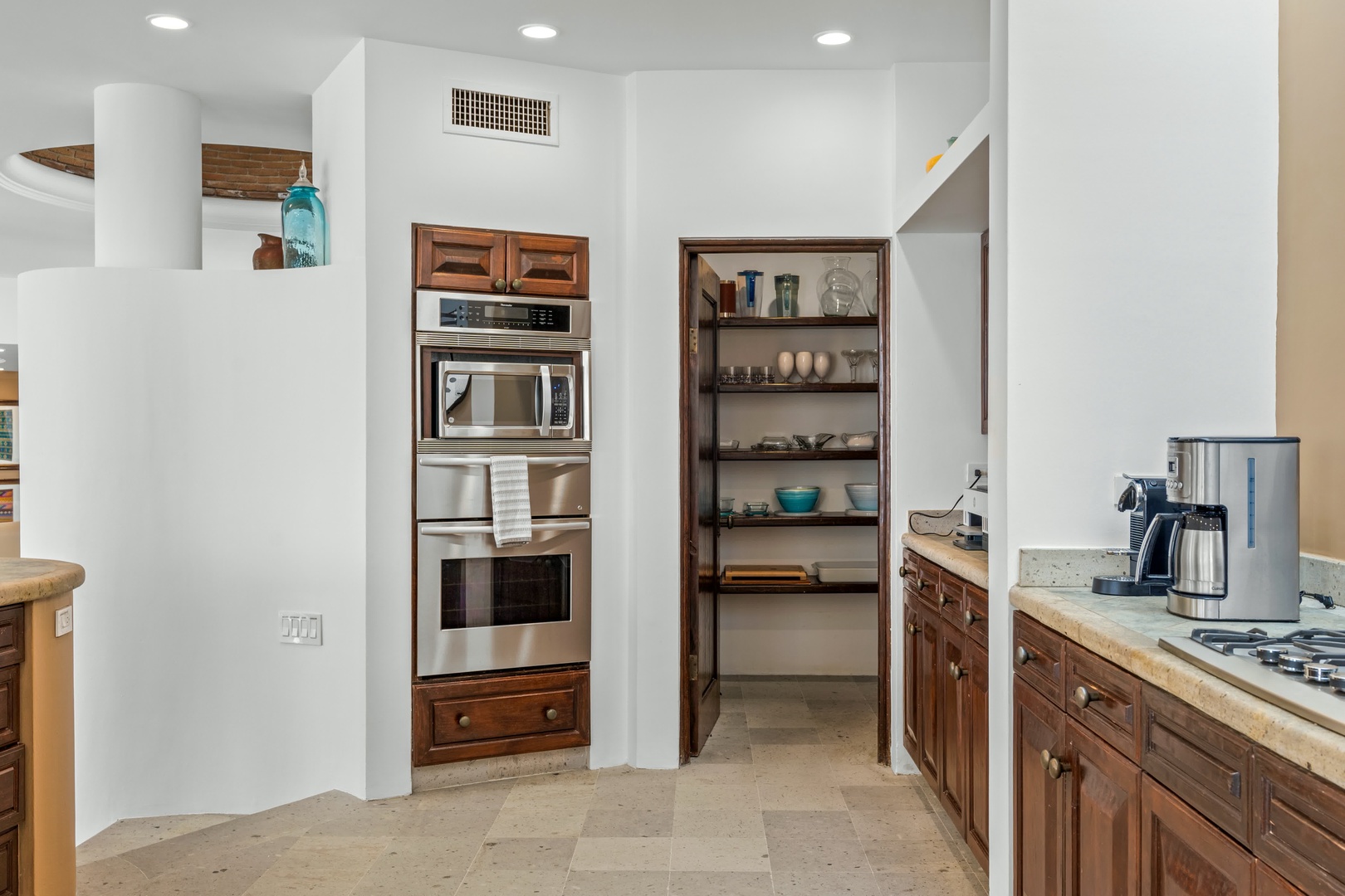 Your gourmet kitchen features rich wood cabinetry, granite counters, and a spacious pantry for all your culinary adventures.