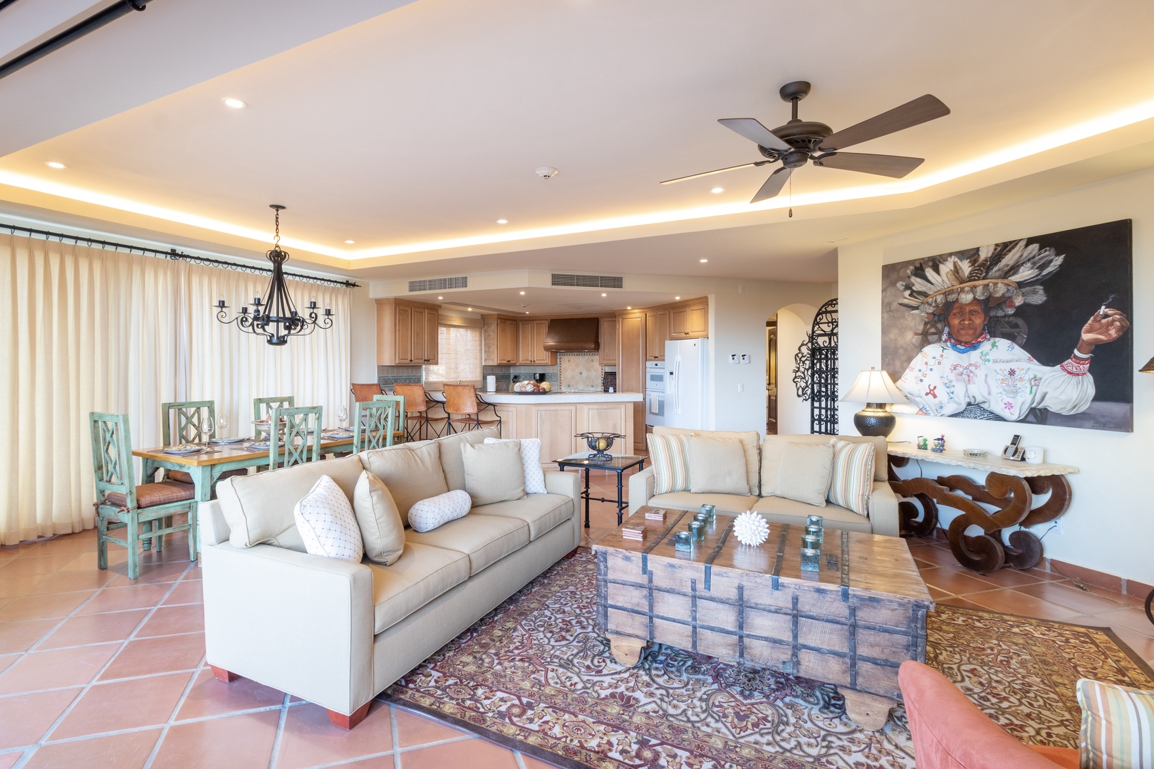 Settle into your inviting living space where warm tones and thoughtful touches create a comfortable home away from home. Relax on plush sofas while enjoying the open layout that flows into your fully-equipped kitchen and dining area.